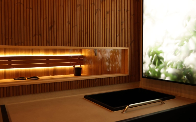 A modern interior at New Era with wood panelling, a built-in shelf with small decor items and a large backlit artwork on the wall.
