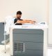 A man relaxes in an Avantopool Kinos hydrotherapy tub, a towel draped on the side and a ladder in the background.